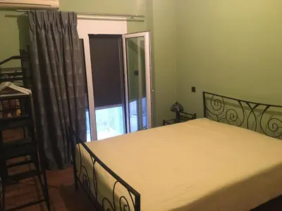 a bedroom with a bed and a large window at Cosy and comfort flat, heart of Athens in Athens