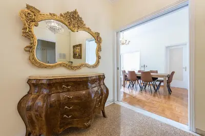 a room with a mirror on the wall and a table at Victoria Queens Palace Apartments in Athens