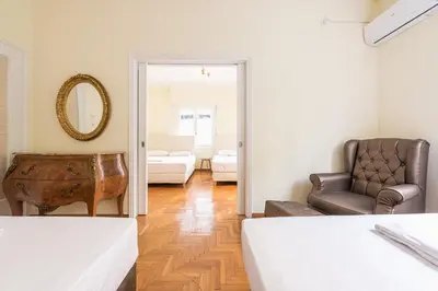 a room with a bed and a chair and a mirror at Victoria Queens Palace Apartments in Athens