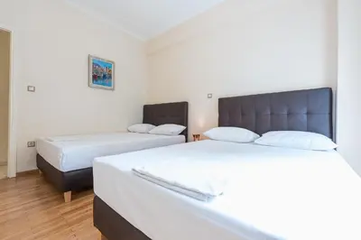 two beds in a small room with two beds at Victoria Familia Apartments in Athens