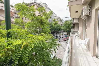 a balcony view of a street with trees and cars at Victoria Familia Apartments in Athens