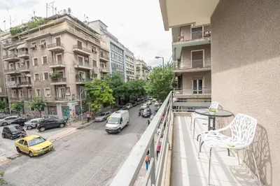 a balcony with a view of a city street with cars at Victoria Familia Apartments in Athens