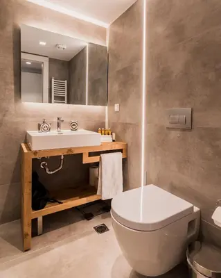 a bathroom with a toilet and a sink and a mirror at Acropolis Luxury Living in Athens