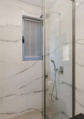 a shower with a glass door in a bathroom at Acropolis Luxury Living in Athens