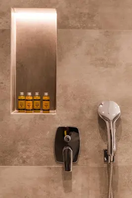 a bathroom with a mirror and some bottles of honey at Acropolis Luxury Living in Athens