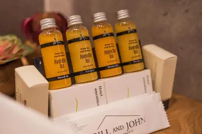 a group of four bottles of honey sitting on boxes at Acropolis Luxury Living in Athens