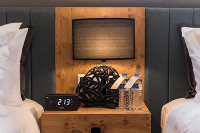a nightstand with a television and a table with a lamp at Acropolis Luxury Living in Athens