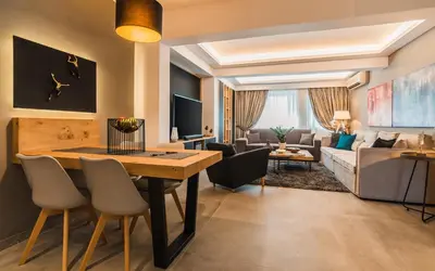 a living room with a dining room table and a couch at Acropolis Luxury Living in Athens