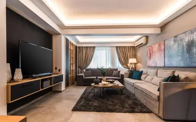 a living room with a couch and a tv at Acropolis Luxury Living in Athens