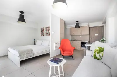 a living room with a bed and a couch and a table at Supreme C2 Apartment in Syntagma in Athens