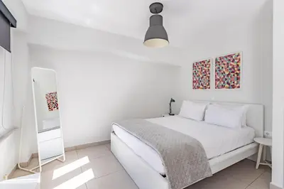 a white bedroom with a bed and a mirror at Supreme C2 Apartment in Syntagma in Athens