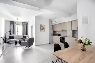 a kitchen and living room with a table and chairs at Supreme B2 Apartment in Syntagma in Athens