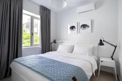 a white bedroom with a bed and a window at Supreme B2 Apartment in Syntagma in Athens