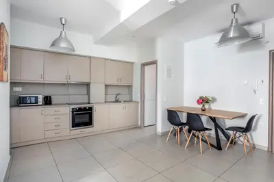 a kitchen with a table and chairs in it at Supreme B2 Apartment in Syntagma in Athens