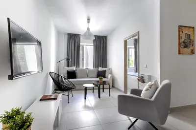 a white living room with a couch and chairs at Supreme B2 Apartment in Syntagma in Athens
