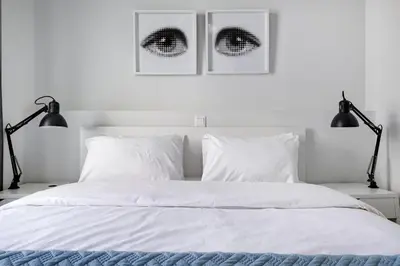 a white bedroom with two lamps and a bed at Supreme B2 Apartment in Syntagma in Athens
