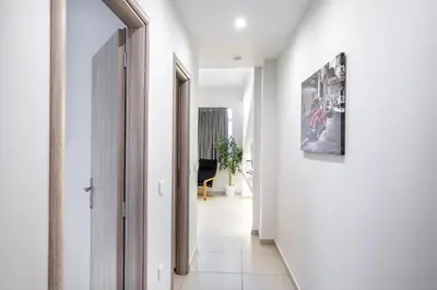 a hallway with white walls and an open door at Supreme B1 Apartment in Syntagma in Athens