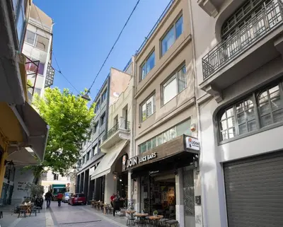 a street with a store on the side of a building at Supreme B1 Apartment in Syntagma in Athens