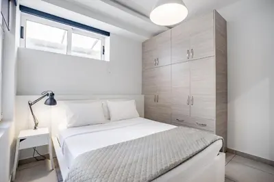a bedroom with a white bed and a window at Supreme B1 Apartment in Syntagma in Athens