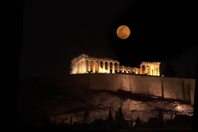 a full moon over the acropolis at night at Acropolis Stylish Suite in Athens