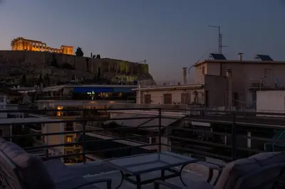 a balcony with a table on top of a building at Acropolis Stylish Suite in Athens