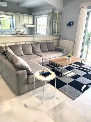 a living room with a couch and a table at Aggelikis House in Spáta