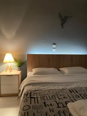 a bedroom with a bed and a lamp on a table at Aggelikis House in Spáta