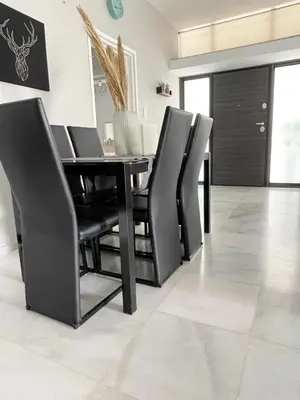a dining room with black chairs and a table at Aggelikis House in Spáta