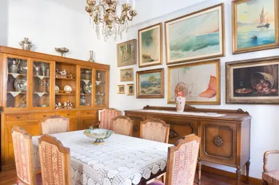 a dining room with a table and some pictures on the wall at Plaka Vintage in Athens