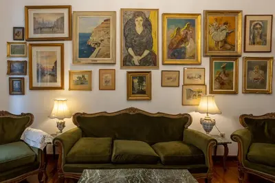 a living room with a couch and a wall of pictures at Plaka Vintage in Athens