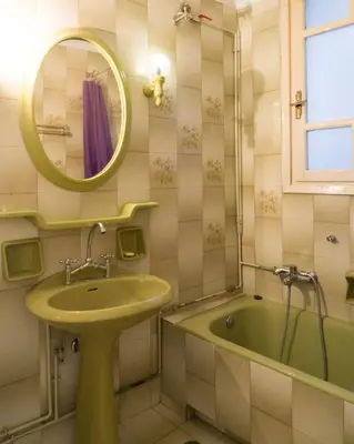a bathroom with a sink and a tub and a mirror at Plaka Vintage in Athens