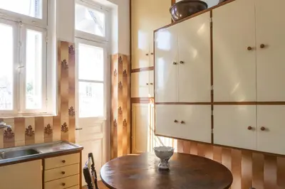a kitchen with a wooden table and a sink at Plaka Vintage in Athens