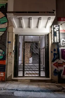 an open door to a building with graffiti on it at AthinA STREETAPARTMENTS in Athens