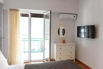 a bedroom with a bed and a mirror and a dresser at Pnyka Apartment 1 in Athens