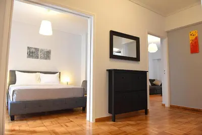 a bedroom with a bed and a mirror at Pnyka Apartment 1 in Athens