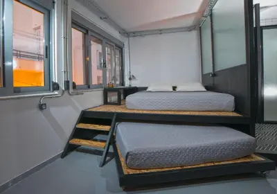 two beds in a small room with windows at Monastiraki #WallsFree CityCenter- Unspoiled Athens Apartments in Athens