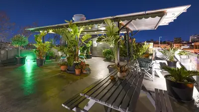 a patio with a bench and potted plants on a roof at Monastiraki #WallsFree CityCenter- Unspoiled Athens Apartments in Athens