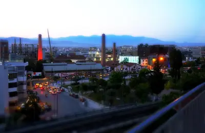 a view of a city at night with cars at Stylish penthouse with Acropolis and 360 view in Athens