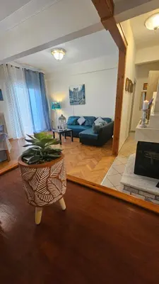 a living room with a couch and a table at Apartment near sea Elpida's Edem in Athens