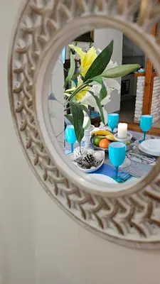 a mirror reflecting a table with a plate of food at Apartment near sea Elpida's Edem in Athens
