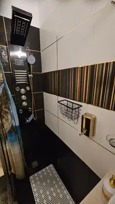 a black and white bathroom with a shower and a sink at Apartment near sea Elpida's Edem in Athens