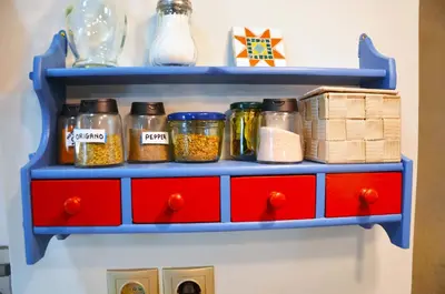 a blue shelf with jars of food on it at Mia's cozy flat in Ermou, 3 min from 