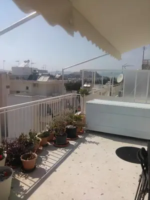 a balcony with potted plants and a bath tub at Mia's Atelier, Balcony to Acropolis in Athens