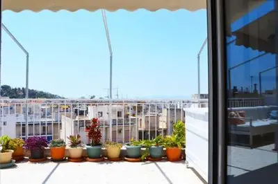 a group of potted plants sitting on a balcony at Mia's Atelier, Balcony to Acropolis in Athens