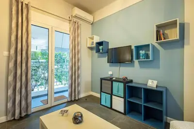 a living room with a tv and a large window at Ruby ' s Best Acropolis Apartment in Athens