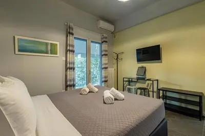 a bedroom with a bed with towels on it at Ruby ' s Best Acropolis Apartment in Athens