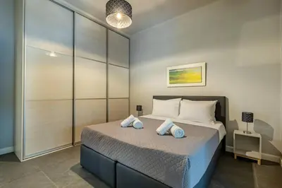 a bedroom with a bed with two pillows on it at Ruby ' s Best Acropolis Apartment in Athens