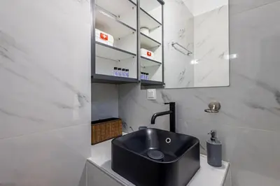 a bathroom with a black sink and a mirror at Ruby ' s Best Acropolis Apartment in Athens