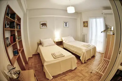 a small room with two beds and a mirror at Top Koukaki Location 3rd floor 2bdr in Athens