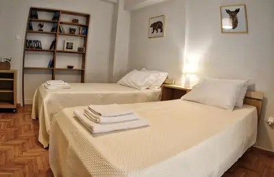 two beds sitting next to each other in a room at Top Koukaki Location 3rd floor 2bdr in Athens